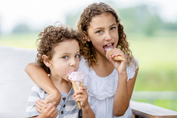 istock Siblings enjoying ice cream cones 1331376616