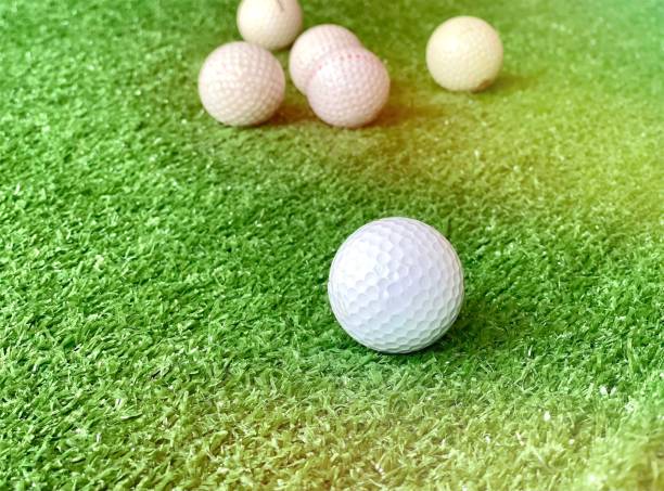 istock Golf balls on green grass of golf course background light shadow 1331378774