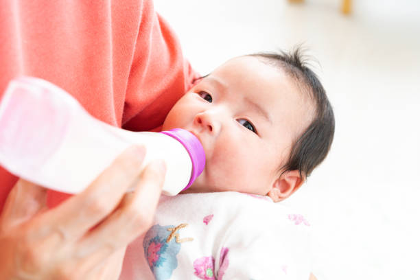 istock Baby drinking milk from bottle 1331381372