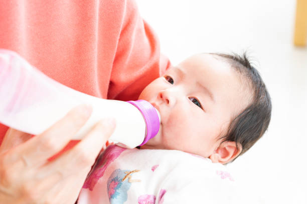 istock Baby drinking milk from bottle 1331381373