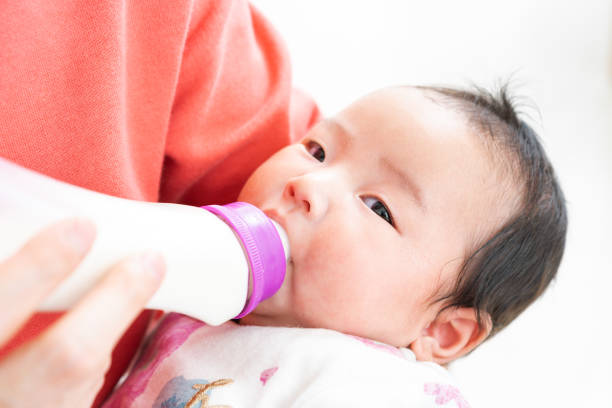 istock Baby drinking milk from bottle 1331381374