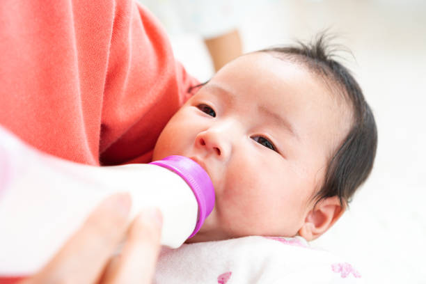 istock Baby drinking milk from bottle 1331381376