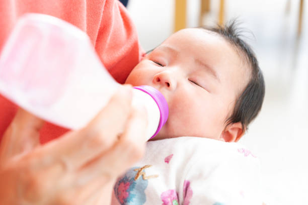 istock Baby drinking milk from bottle 1331381380