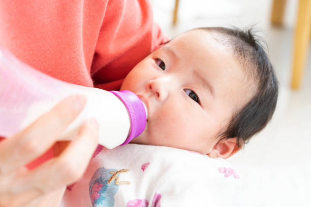 istock Baby drinking milk from bottle 1331381381