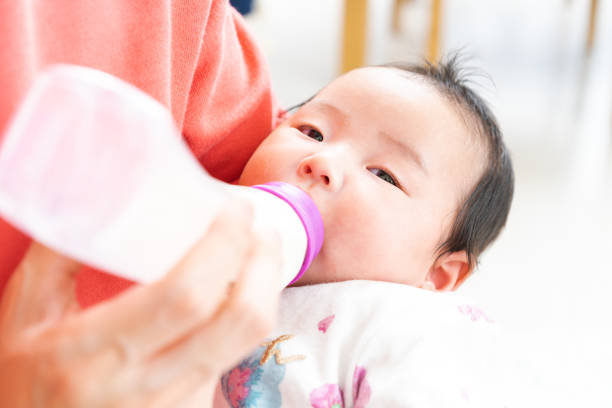 istock Baby drinking milk from bottle 1331381382