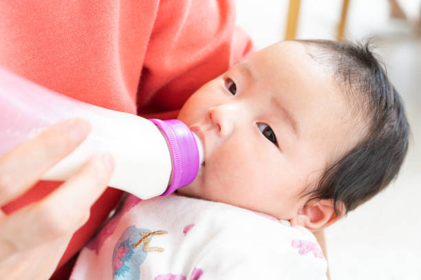istock Baby drinking milk from bottle 1331381386