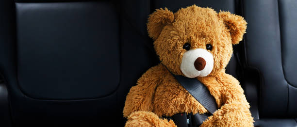 istock Brown teddy bear wearing car seat belt 1331391450