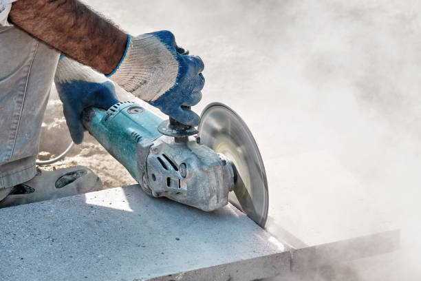 istock Hands of a pavement construction worker using an angle grinder for cutting the tiles 1331393185