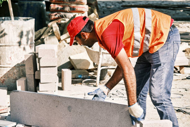 istock Pavement construction worker grabbing a big tile of pavement stone. 1331393273