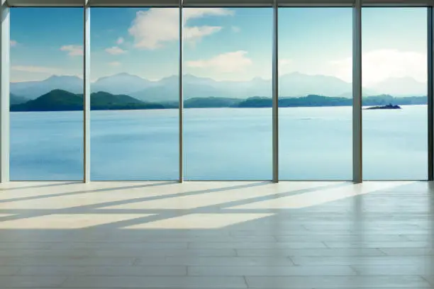 Photo of Through the floor-to-ceiling glass windows, overlooking the mountains in the distance