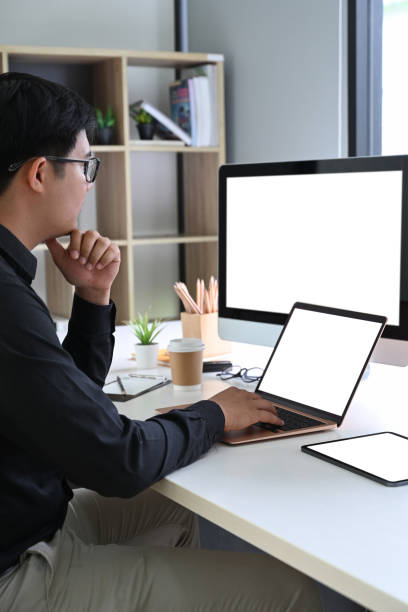 istock Businessman working with multiple devices in his room. 1331395194
