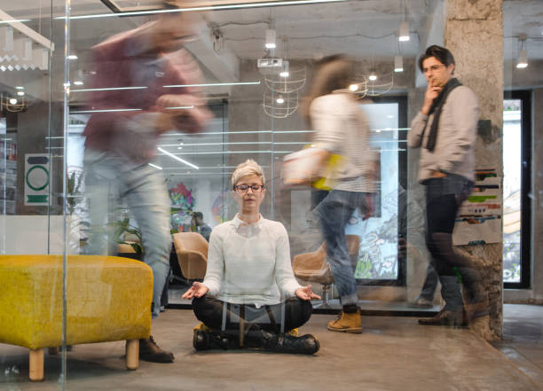 young relaxed female entrepreneur exercising yoga in the office. - yoga meditating business group of people imagens e fotografias de stock