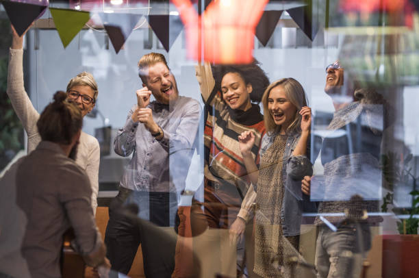 istock Large group of happy entrepreneurs dancing during office party. 1331396257