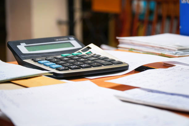 istock An old calculator on the table with documents and business papers 1331402586