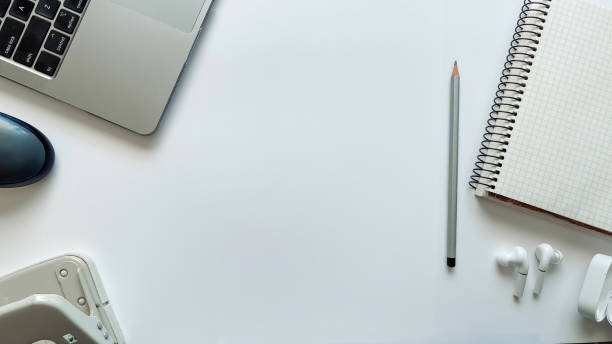 istock Layout on the topic of education or work on a white background with notepad, pen, laptop, computer mouse, folder for papers, hole punch, headphones, pencils 1331404552