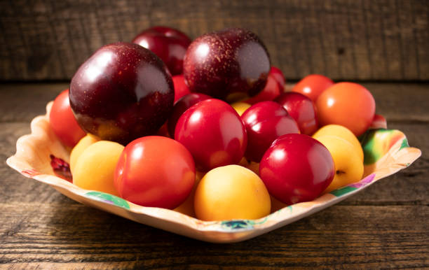 Plums,plums and apricots on a wooden table