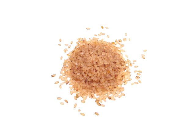 istock brown rice isolated on white background, food ingredient 1331405844