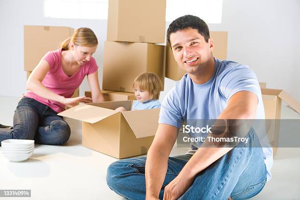 Family Between Boxes Stock Photo - Download Image Now - 2-3 Years, 20-24 Years, Adult