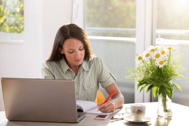 istock Young woman working on laptop at home 1331411765