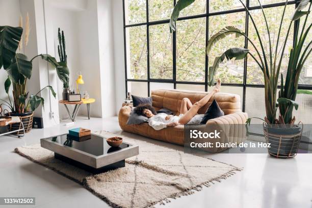 Beautiful And Young African American Woman Sleeping On A Couch In A Big Bright Living Room Copy Space Stock Photo - Download Image Now
