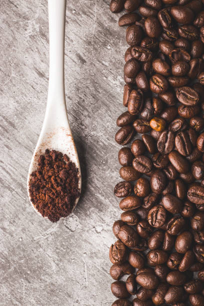 istock Coffee beans and powder with textured background stock image. 1331416274