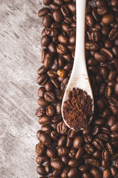 istock Coffee beans and powder with textured background stock image. 1331416297
