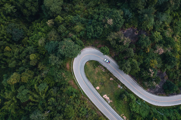 istock mountain road and green trees from above 1331417362
