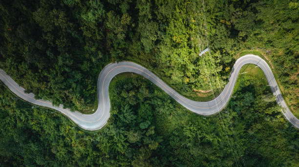 istock mountain road and green trees from above 1331417415