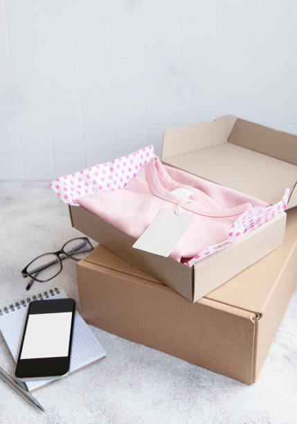 istock Clothes fir kids in an open cardboard box 1331419432