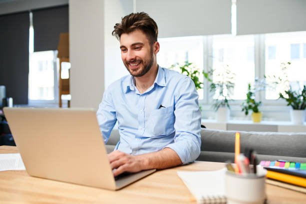 istock Young man freelancer working on laptop from home office 1331421043