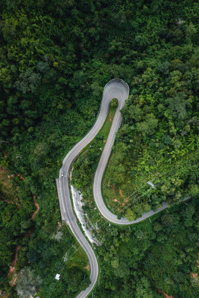 istock mountain road and green trees from above 1331421868