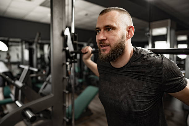istock Strong bodybuilder with muscular chest and shoulders in gym 1331421983