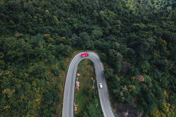 istock mountain road and green trees from above 1331421991