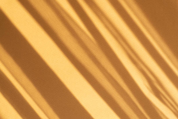 istock Minimalistic abstract textured brown background. Ready-made Mock-Up for your ad. Shadow from sun's rays, in form of oblique stripes, falls on surface 1331427271