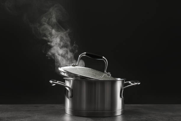 istock Steaming saucepot on grey table against dark background 1331427895
