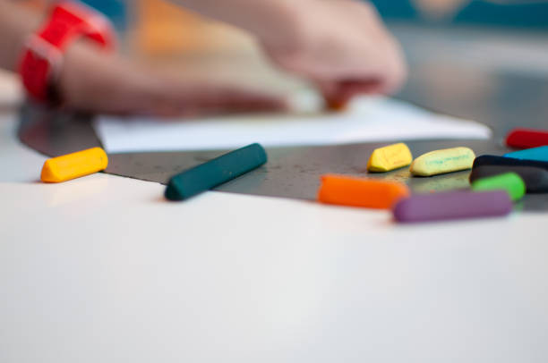 istock Kid drawing with crayons on paper. 1331429678