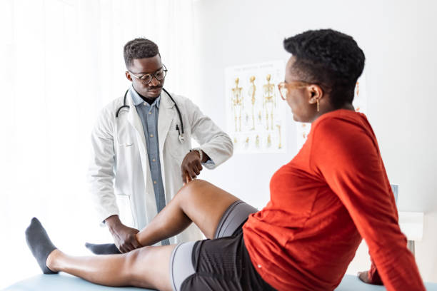 istock Doctor giving a patient a leg treatment 1331432539
