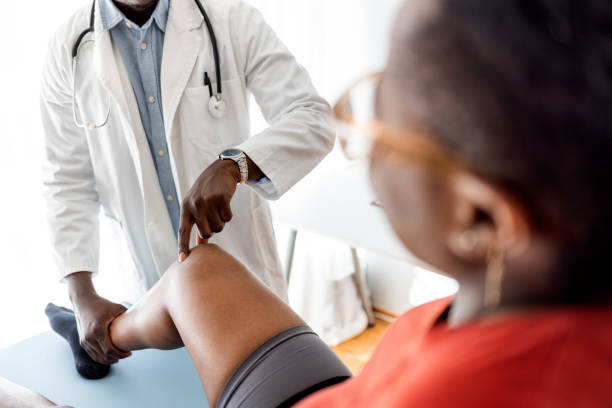 istock Doctor examining patient knee 1331432551