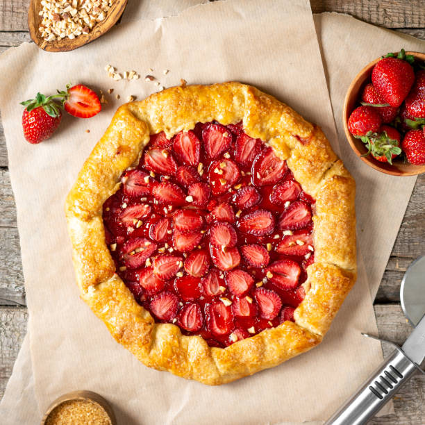 istock French galette or pie with strawberries and almonds on baking paper on a culinary background top view. Summer homemade sweet pastries 1331432646