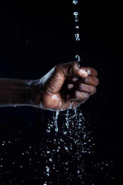 istock African man hands interacting with water. 1331435173