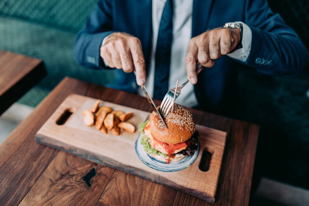 istock Senior businessman at restaurant table 1331436038