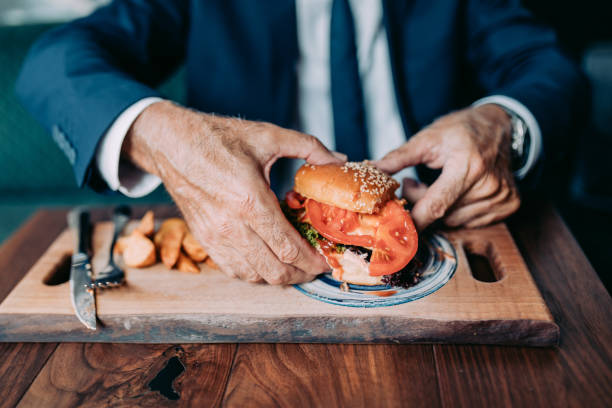 istock Senior businessman at restaurant table 1331436069