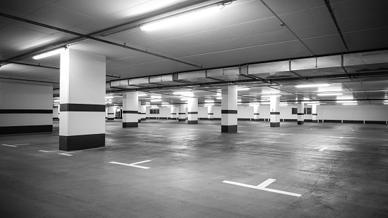 large underground car park, gloomy atmosphere in black and white