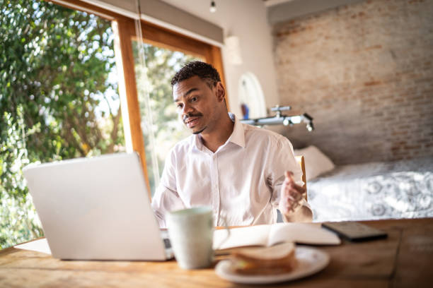 istock Man doing a virtual business call at home 1331437507