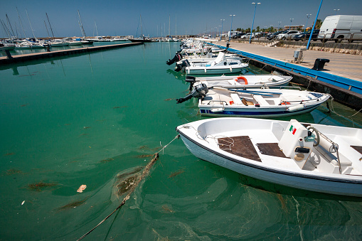 San Leone Marina in Agrigento, Sicily. This was once a Greek port. Here, cars and boat names are visible in the background.