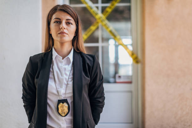 Woman detective at the crime scene Portrait of detective in front of crime scene, before giving statement for the press fbi photos stock pictures, royalty-free photos & images