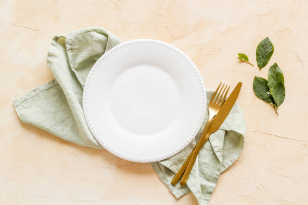 istock Empty tableware with tablecloth top view. Plate with fork and knife on napkin 1331441626