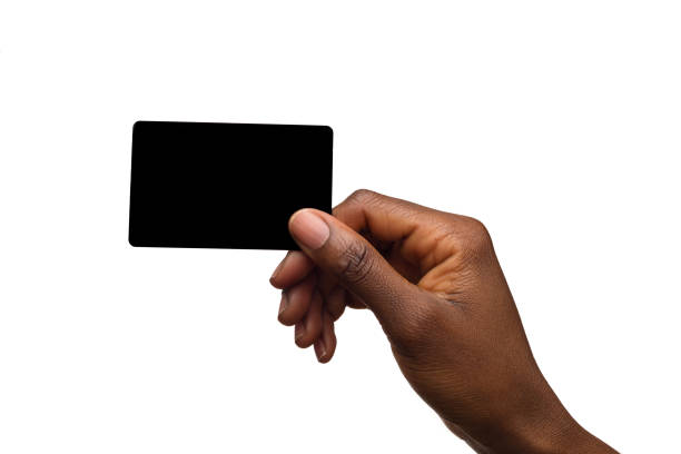 Black Female Hand Holding Black Card Black Female Hand Holding Black Card. Close up isolated on white. hand holding gift stock pictures, royalty-free photos & images