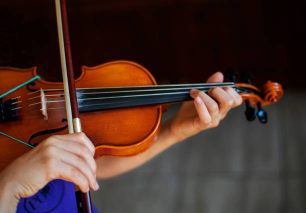 istock little violinist playing the violin top view, horizontal 1331443987