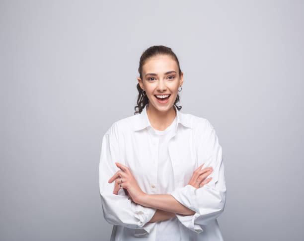 istock Happy young woman in white shirt 1331444568